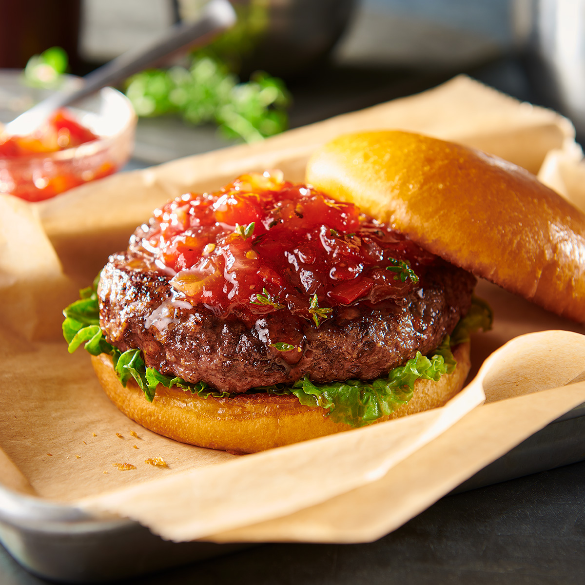 burger with tomato onion jam on tray