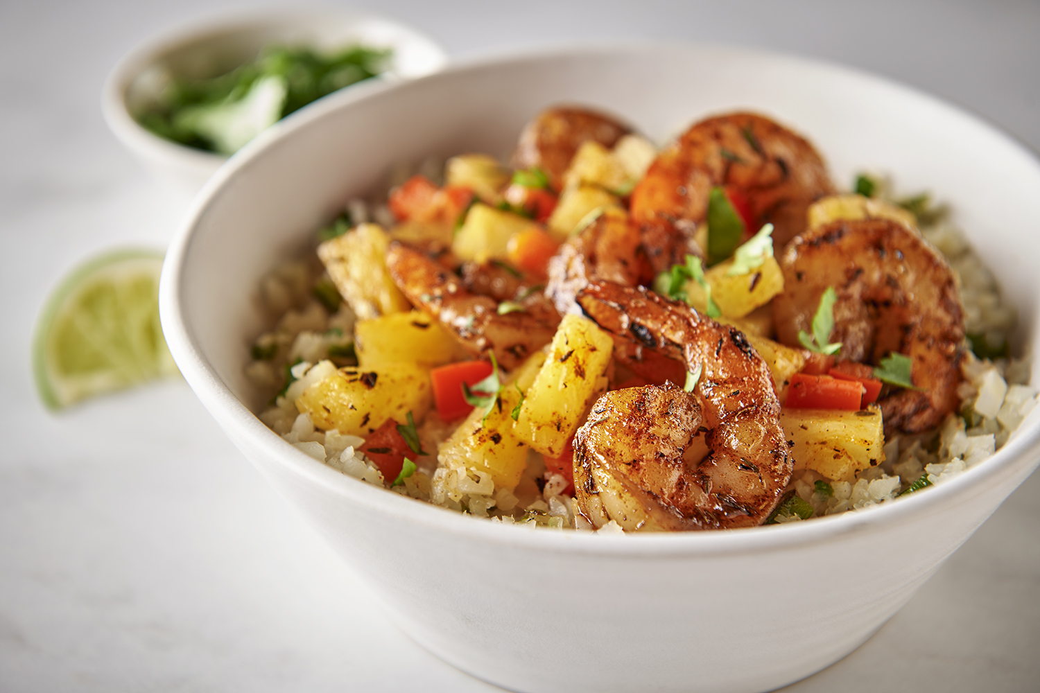 Del Monte Pineapple Tidbits in Jerk Shrimp Bowl on top of Del Monte Cauliflower Rice